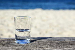 Opti-pessimism is a design framework that looks at this metaphorical glass (image licensed from Adobe Stock) from both the half-empty and half-full perspectives in a human context. 